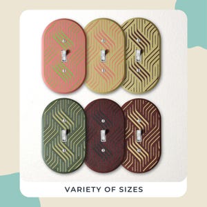 May include: Six decorative light switch covers in various colours, including pink, yellow, green, and burgundy. Each cover features a geometric pattern and a toggle switch. The text "VARIETY OF SIZES" is at the bottom.