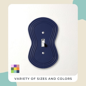 May include: A navy blue light switch cover with a distinctive, wavy design. It features a white toggle switch and is mounted on a white wall. The text "VARIETY OF SIZES AND COLORS" is at the bottom, accompanied by a colour palette.