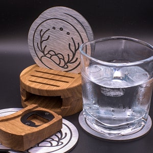 May include: A set of four coasters with a wooden bottle opener. The coasters are made of metal and have a brushed finish. The bottle opener is made of wood and has a metal opener. The coasters are stacked on top of each other, with the bottle opener in the middle. A glass of water is sitting on one of the coasters.