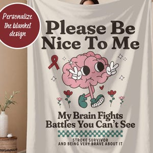 May include: A cream-colored blanket with the text "Please Be Nice To Me" and "My Brain Fights Battles You Can't See." The design includes a cartoon brain, flowers, and a ribbon. The blanket is held up by a person.