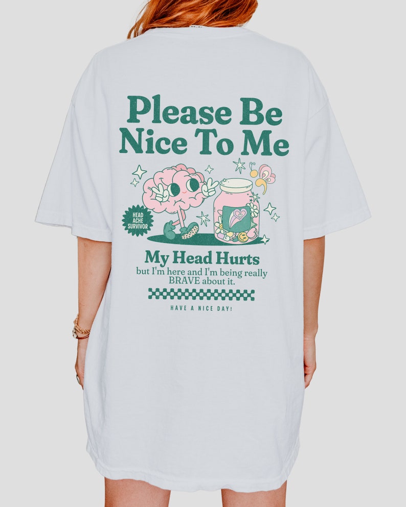 May include: White t-shirt with a green and pink graphic of a brain in a jar with the text "Please Be Nice To Me", "My Head Hurts but I'm here and I'm being really BRAVE about it." and "HAVE A NICE DAY!"