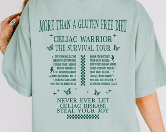 May include: A light blue t-shirt with a green graphic print that reads "More than a gluten free diet. Celiac Warrior. The Survival Tour." The graphic also includes a list of challenges faced by people with celiac disease. The bottom of the graphic reads "Never ever let celiac disease steal your joy."