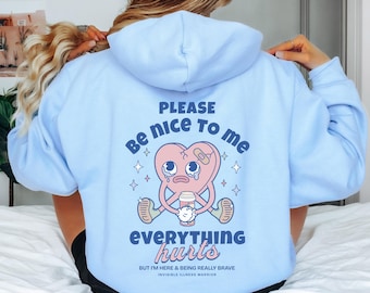May include: Light blue hoodie with a cartoon heart graphic and the text "Please be nice to me everything hurts but I'm here & being really brave invisible illness warrior".