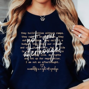 May include: Navy blue sweatshirt with a white butterfly graphic and the text "Not your afterthought. Accessibility is a right, not a privilege."