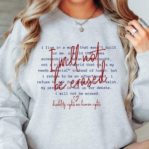 May include: Gray sweatshirt with a red graphic print that reads "I will not be erased. Disability rights are human rights."