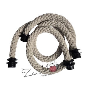 May include: A set of beige rope handles with black plastic end pieces. The rope is thick and braided, and the handles are arranged in a circular pattern. The image includes the text "Za Motek HAND MADE".