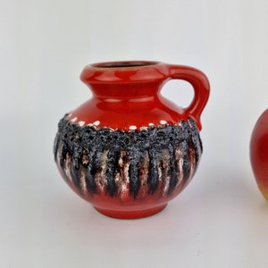 A West German Fat Lava vase made by Schlossberg. The vase is red, black and white and is numbered: 78 10.
