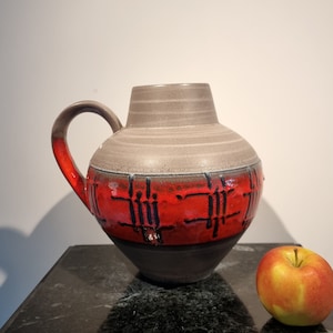 A beautiful West German Fat Lava vase made by Carstens Tonnieshof. The vase is red and gray and is numbered: 698-23.
