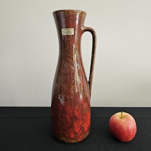A beautiful West German Fat Lava vase made by Carstens Tonnieshof. The vase is red and gold and is numbered 6013-30.