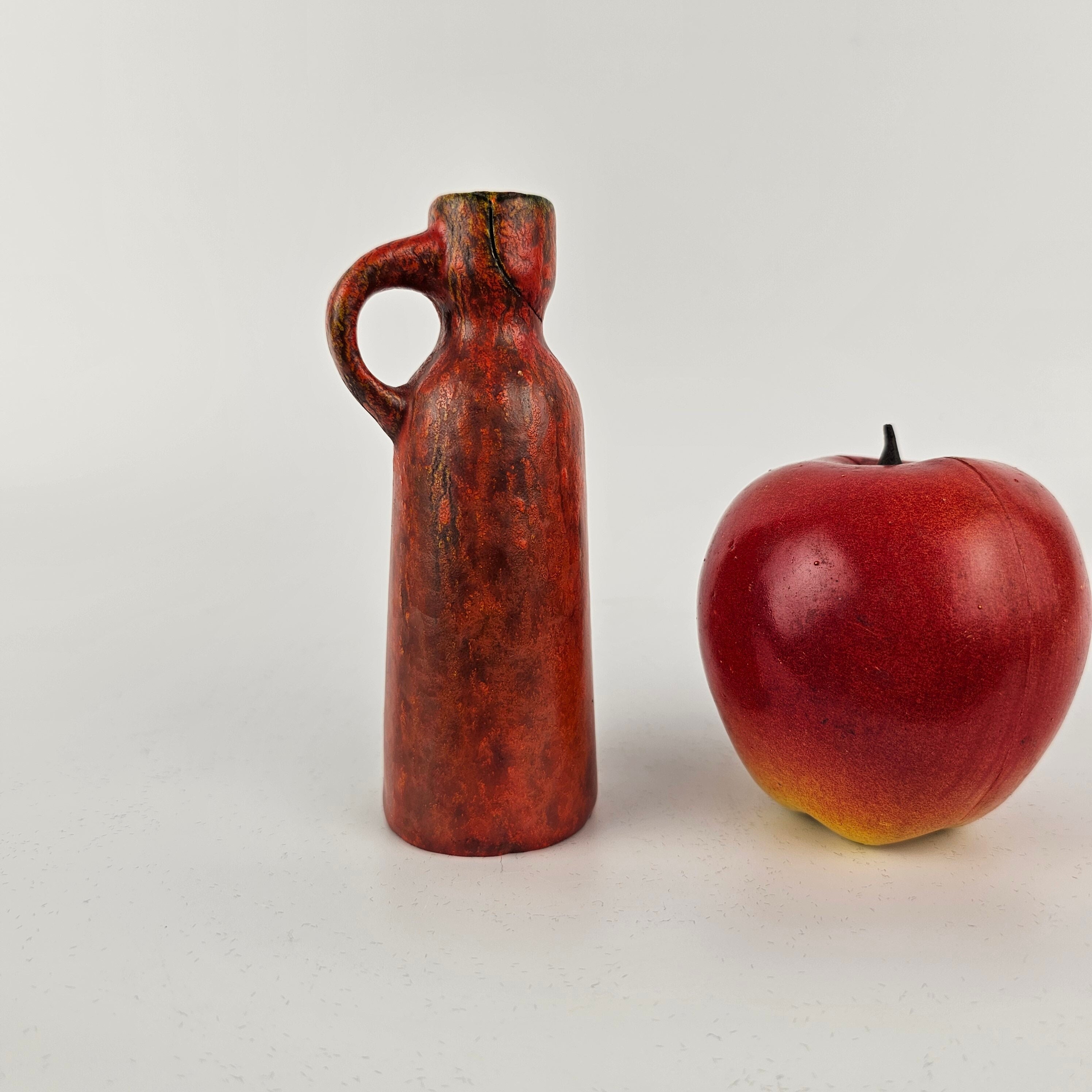 A West German Fat Lava vase made by Ruscha. The vase is Red "Vulkano" glaze and is numbered: 342/1.