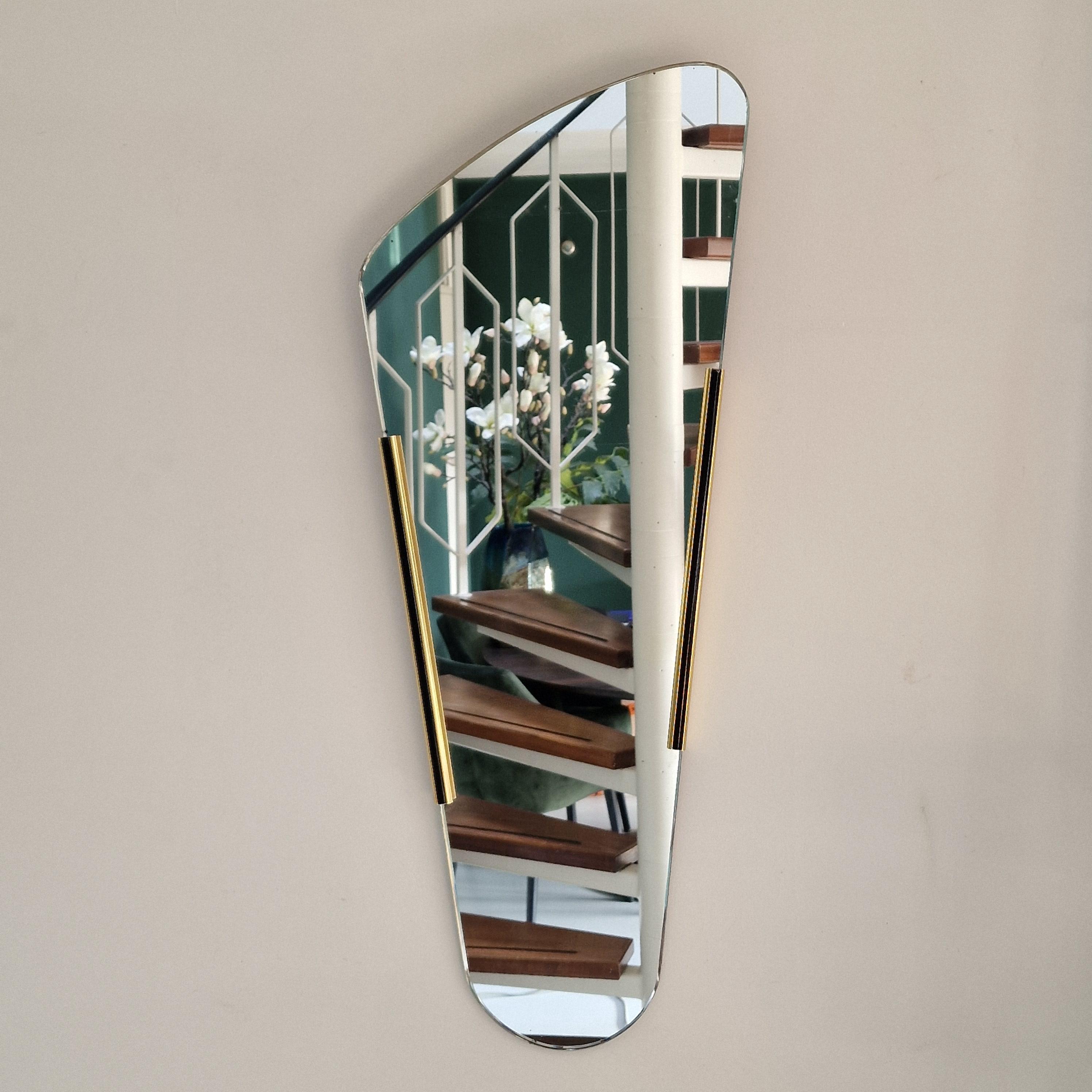Vintage mirror from the 50s/60s. Oblong mirror with brass frame. Retro asymmetrical wall mirror.