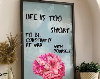 May include: A rectangular framed wall art piece featuring a light blue sky background with white clouds. The black text reads: LIFE IS TOO SHORT TO BE CONSTANTLY AT WAR WITH YOURSELF. Below the text is a pink brain made of flower petals.