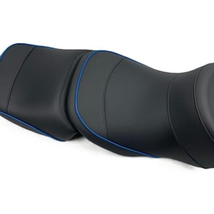 Puede incluir: Un asiento de motocicleta negro con ribete azul. El asiento tiene un diseño contorneado con detalles cosidos. El asiento está diseñado para la comodidad y el soporte durante los viajes largos. Fabricado con material resistente.