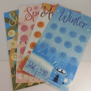 May include: Four cards depicting different seasons, each with a total number of points. The cards are blue, pink, orange, and green. The total points are 330.