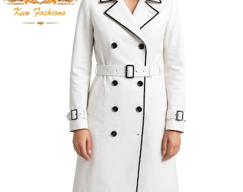 May include: A white trench coat with a black trim around the collar, cuffs, and pockets. The coat has a double-breasted closure and a belt.