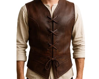 May include: A brown leather vest with a lace-up front and a V-neck. The vest has a fitted silhouette and a tie closure at the waist. The vest is worn over a light-colored long-sleeved shirt.
