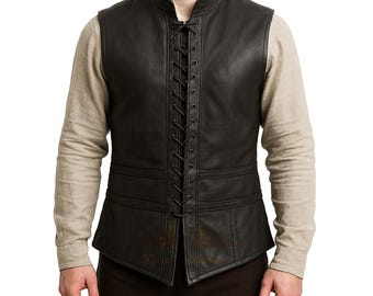 May include: Black leather vest with a lace-up front and a stand-up collar. The vest has a fitted silhouette and features detailed stitching and paneling. The vest is worn over a long-sleeved beige shirt.