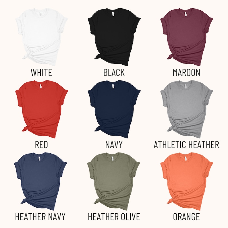 May include: A set of ten t-shirts in various colors, including white, black, maroon, red, navy, athletic heather, heather navy, heather olive, and orange. The shirts are all folded and laid out on a white background.