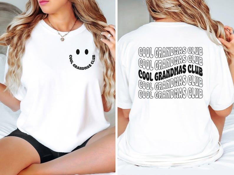 May include: White t-shirt with the text "COOL GRANDMAS CLUB" on the back in a wavy design. The front features a smiley face with the text "COOL GRANDMAS CLUB" in a curved design. A casual, comfortable tee.