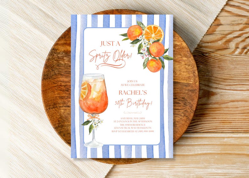 May include: A blue and white striped invitation with an illustration of a glass of orange juice and orange blossoms. The text reads "Just a Spritz Older" and "Rachel's 30th Birthday!"