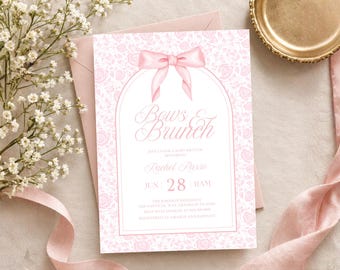 May include: A rectangular invitation card featuring a light pink floral pattern background, a central white arch frame, and a pink bow illustration at the top. The text reads Bows & Brunch, honoring Rachel Russo, June 28, 11AM, with event details.