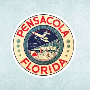 May include: A vintage travel sticker with a red, white, and blue design. The sticker features a plane flying over a beach scene with palm trees and people swimming. The text on the sticker reads "Pensacola, Florida, The Playground of the South".