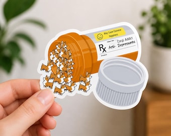 May include: A sticker depicting an orange pill bottle with a white label and a grey cap. The label reads "Corgi Addict Anti-Depressants" and "May Cause Extreme Happiness." Cartoon corgi dogs are spilling out of the bottle, creating a playful design.
