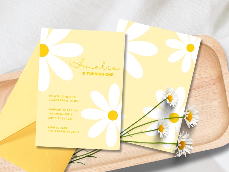 May include: Yellow and white birthday invitation with a daisy pattern. The text reads "Amelia is turning one. Please come and celebrate with us! January 12 at 2 PM, 123 Anywhere St, Any City ST 1234. RSVP to Jane +123-456-789 by Jan 8."