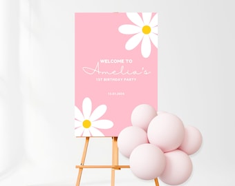 May include: Pink welcome sign with white daisies and the text "Welcome to Amelia's 1st Birthday Party 12.01.2024".