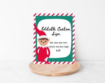 May include: A custom sign with an elf illustration. The sign has a white background with the text "Editable Custom Sign". The sign is 8x10 inches and has a green border with a red and white candy cane stripe.