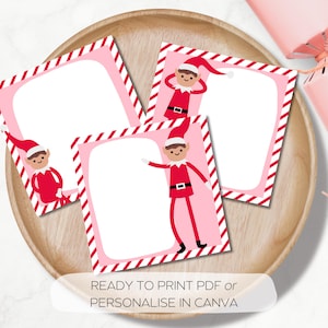 May include: A wooden tray holds three pink and white Christmas-themed cards with elf illustrations. Each card has a white center for writing and a red and white striped border. The text "READY TO PRINT PDF OR PERSONALIZE IN CANVA" is at the bottom.