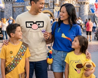 May include: A family wearing Disney-themed apparel: a beige t-shirt with Carl Fredricksen's glasses, a blue t-shirt with Kevin the bird, a yellow t-shirt with a Wilderness Explorer sash, and a yellow t-shirt with Dug the dog graphic.