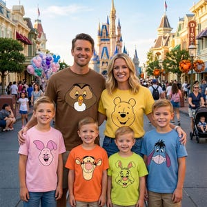 May include: A group of six people wearing matching t-shirts featuring various cartoon characters. The shirts display graphic prints of Owl, Winnie the Pooh, Piglet, Tigger, Rabbit, and Eeyore. The individuals are standing together outdoors.