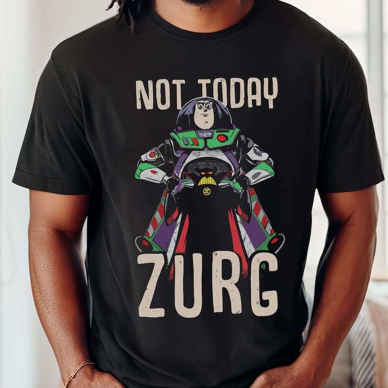 May include: A black t-shirt with a graphic of Buzz Lightyear from Toy Story riding a spaceship with the text "Not Today Zurg".