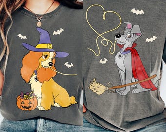 May include: Two gray t-shirts featuring cartoon dogs in Halloween costumes. One shirt shows a dog in a witch hat with a pumpkin. The other shirt shows a dog with a cape and a broom, with bat graphics.