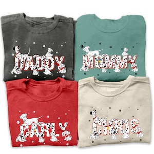 May include: Four grey, teal, red, and beige sweatshirts with a Dalmatian dog design. The sweatshirts have the words "Daddy", "Mommy", "Carly", and "Chris" spelled out with Dalmatian puppies.