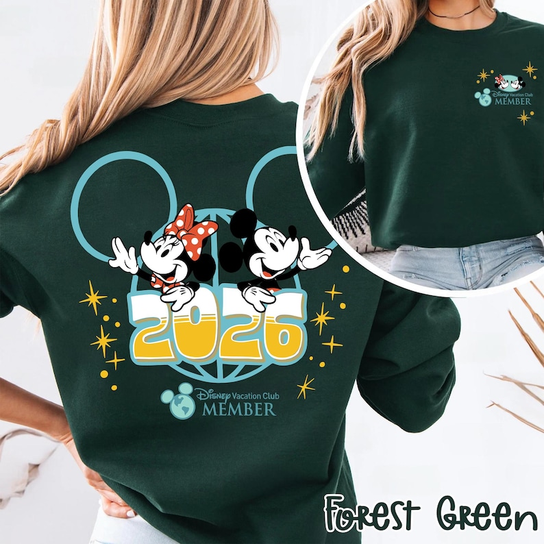 May include: A forest green sweatshirt with a design featuring Mickey and Minnie Mouse, the year 2026, and the text "Disney Vacation Club MEMBER". The design includes a Mickey Mouse ear outline and stars.