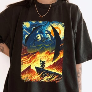 May include: Black t-shirt with a graphic print of a cartoon demon with wings, standing in a fiery landscape inspired by Vincent van Gogh's Starry Night.