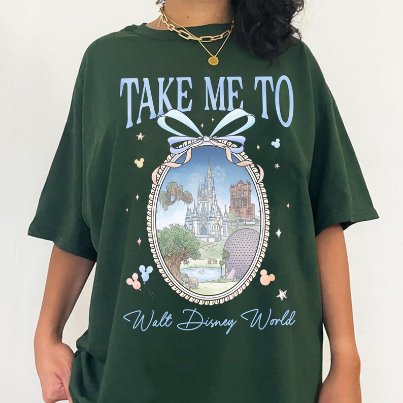 May include: Dark green t-shirt with the text "TAKE ME TO Walt Disney World" in light blue script. The shirt features a framed image of a Disney park with a castle, tower, and sphere. Mickey Mouse icons are on the shirt.