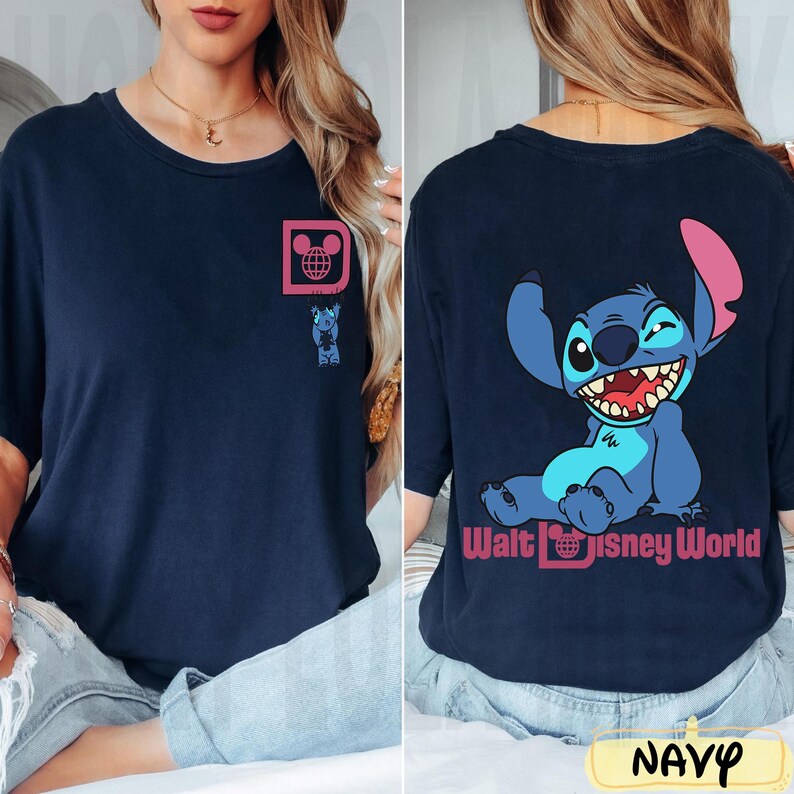 May include: Navy blue t-shirt featuring a cartoon Stitch character design. The front has a small pink square with a Mickey Mouse head and globe graphic, and a Stitch graphic. The back has a large Stitch graphic and "Walt Disney World" text.