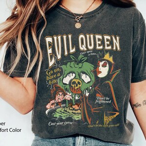 May include: Black t-shirt with a graphic print of the Evil Queen from Snow White. The graphic includes the text "Evil Queen", "Once upon a time", "Go on, have a bite", "Cast your curse", "Don't be frightened", and "Don't let the ash grow cold".