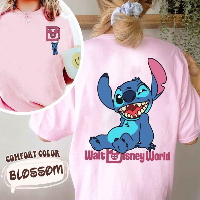 May include: Pink Comfort Colors t-shirt with a small Stitch graphic on the front and a larger Stitch graphic with "Walt Disney World" text on the back. The shirt is a light pink color, with the word "Blossom" in a speech bubble.