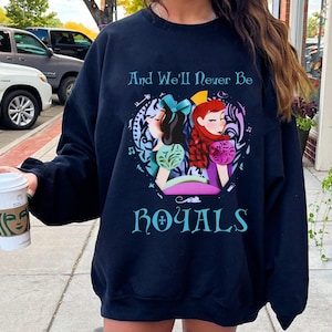 May include: Black sweatshirt with a graphic print of two cartoon women with the text "And We'll Never Be Royals".