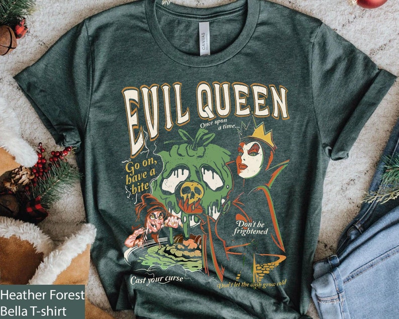 May include: A dark green t-shirt with a vintage-style graphic of the Evil Queen from Snow White. The graphic features the Evil Queen holding a poisoned apple, with the text "Evil Queen", "Go on, have a bite", "Don't be frightened", and "Cast your curse".