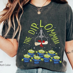 May include: A dark gray t-shirt with a green graphic of the claw from Toy Story grabbing a diploma with the text "The Dip L'ommaaa".  The graphic also includes green alien characters from Toy Story.
