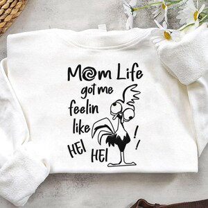 May include: White sweatshirt with a black and white illustration of a rooster with the text "Mom Life got me feelin like Hei Hei!"