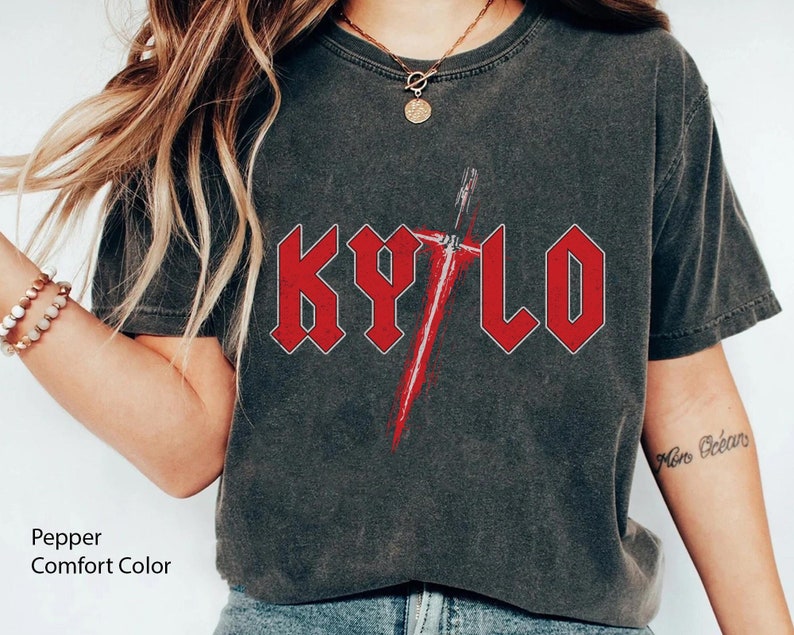 May include: A dark grey t-shirt with a red graphic of the word "KYLO" in a heavy metal font with a red lightsaber behind it.