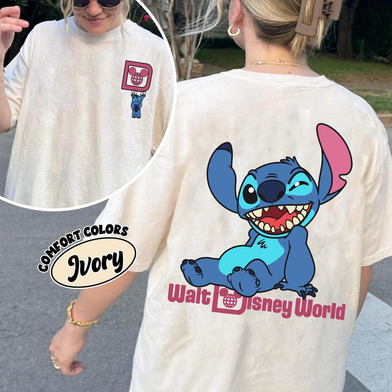 May include: Ivory-colored Comfort Colors t-shirt featuring a cartoon Stitch character on the back, with the words "Walt Disney World" below. The front has a small graphic of Stitch and a Mickey Mouse head.
