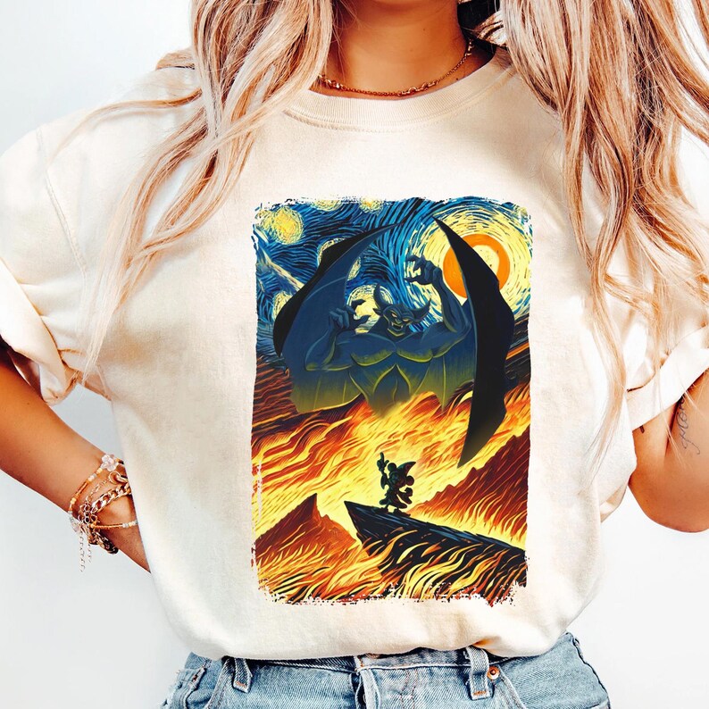 May include: A white t-shirt with a graphic print of a blue and green demon with wings, standing over a fiery landscape. The background is a starry night sky, reminiscent of Vincent van Gogh's 'Starry Night'.
