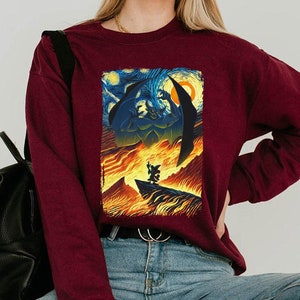 May include: A maroon long-sleeve sweatshirt with a graphic print of a scene from the movie "The Nightmare Before Christmas". The print features Jack Skellington and Sally in a fiery landscape inspired by Vincent van Gogh's "Starry Night".